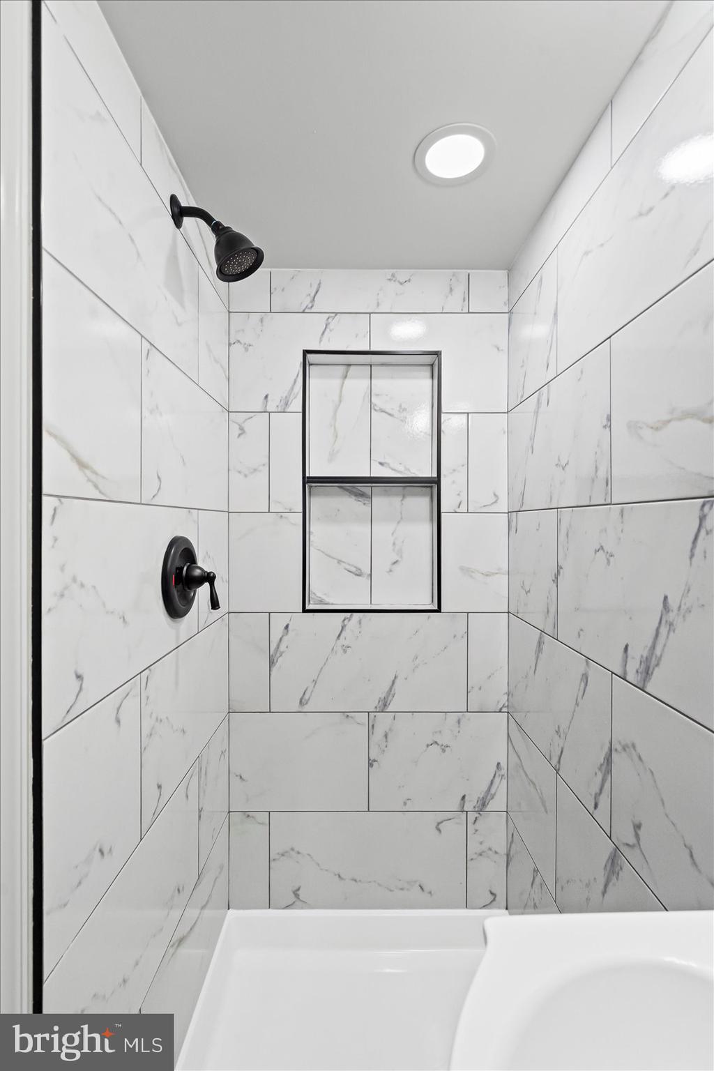 1812 Ingram Road Baltimore, MD 21239 - Photo 36 of 45 a bathroom with a bathtub and shower