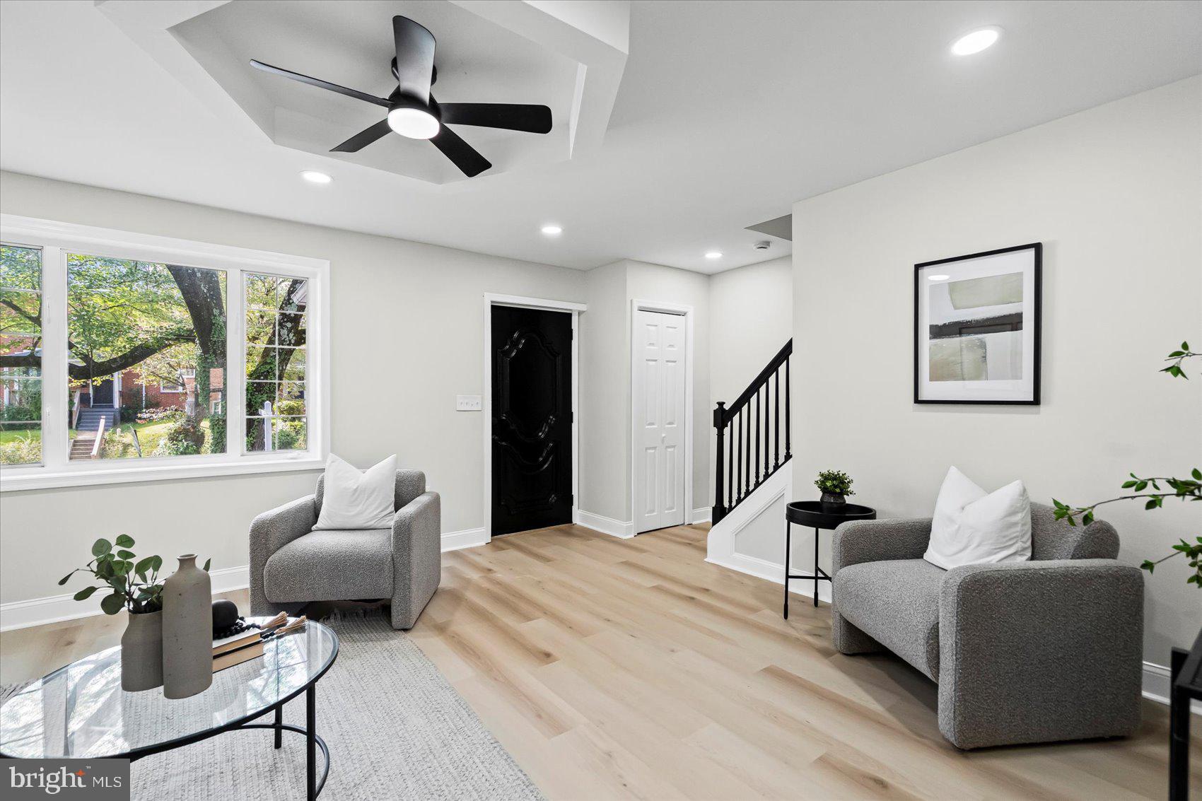 1812 Ingram Road Baltimore, MD 21239 - Photo 5 of 45 a living room with furniture ceiling fan and a large window