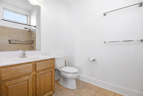 a bathroom with a granite countertop sink toilet and a mirror