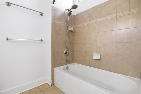 a bathroom with a tub a shower and a sink