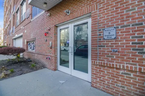 a view of a brick house with a potted plant