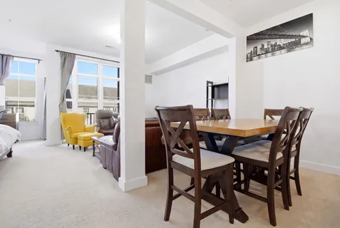 a view of a dining room with furniture and a table and chairs
