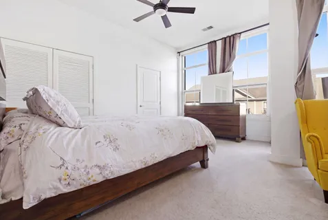 a bedroom with a bed dresser and a window