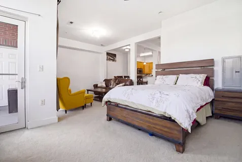 a spacious bedroom with a bed and a couch