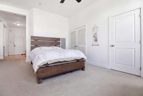 a bedroom with a bed and a chandelier