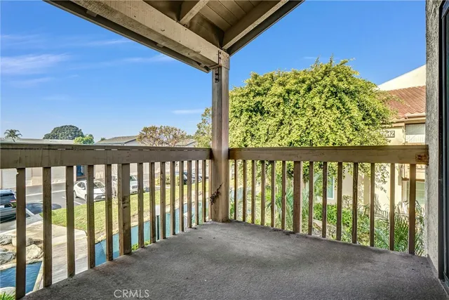 a view of a hallway with wooden cabinets and entryway