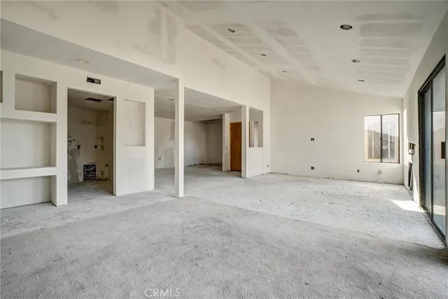 a view of empty room with a fireplace and windows