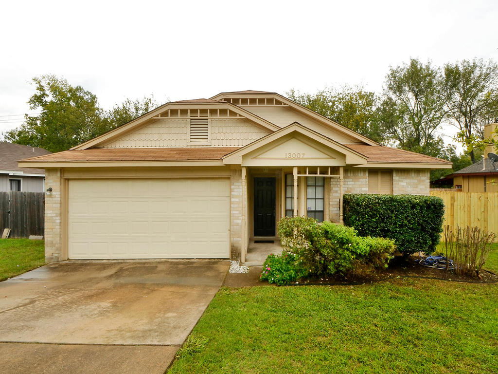 13007 Rampart Street Austin, TX 78727 - Photo 1 of 1 a front view of a house with a garden and plants