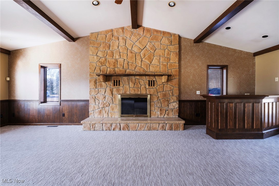 7059 Stewart Sharon Road Hubbard, OH 44425 - Photo 12 of 49 Unfurnished living room featuring carpet flooring, wainscoting, and vaulted ceiling with beams
