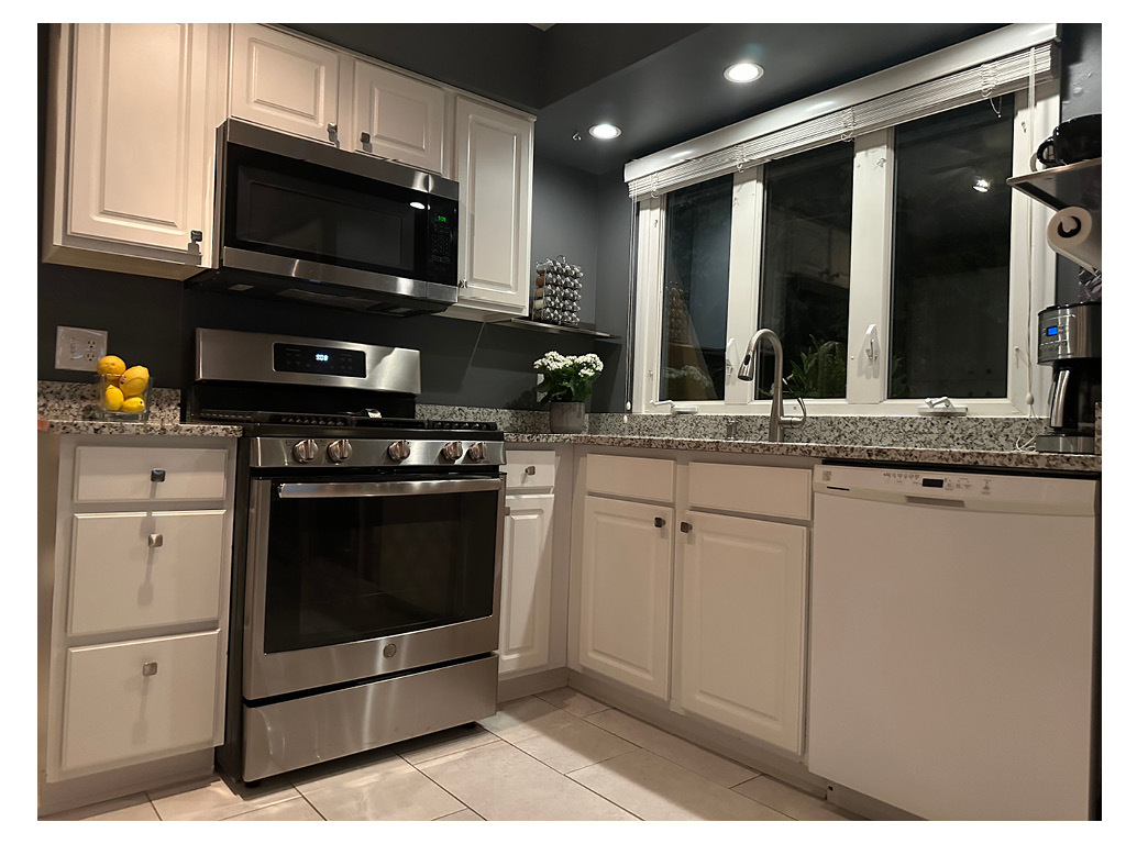 129 Regency Drive Lombard, IL 60148 - Photo 12 of 58 a kitchen with stainless steel appliances granite countertop a stove microwave and cabinets