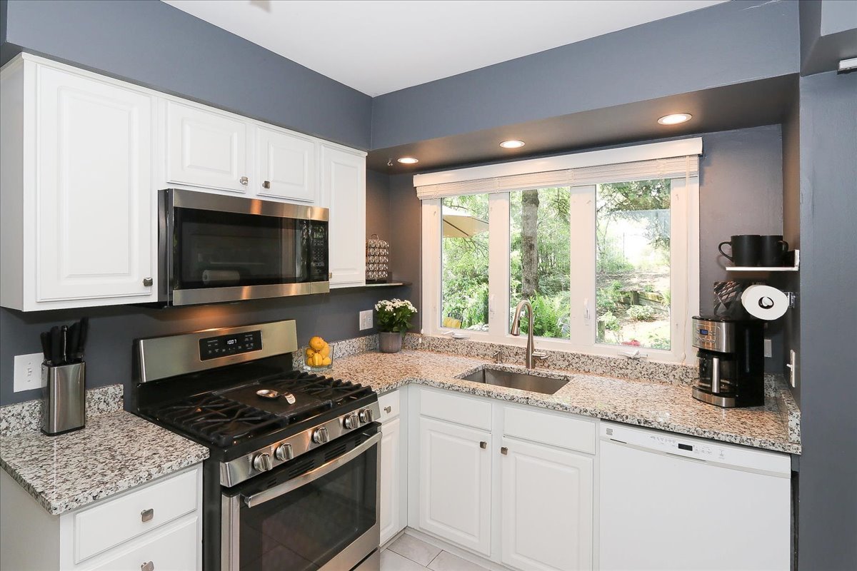 129 Regency Drive Lombard, IL 60148 - Photo 13 of 58 a kitchen with granite countertop a stove and a sink