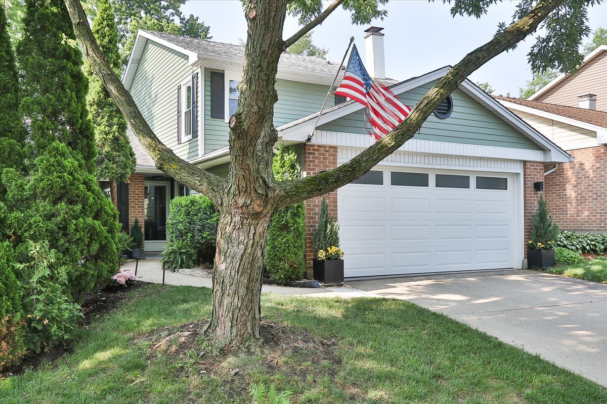 129 Regency Drive Lombard, IL 60148 - Photo 3 of 58 a view of a house with a yard and garage