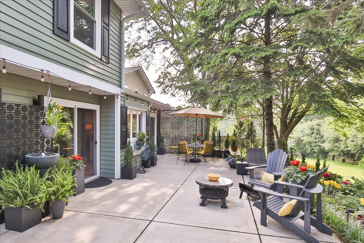 129 Regency Drive Lombard, IL 60148 - Photo 39 of 58 a view of a patio with couches table and chairs and potted plants
