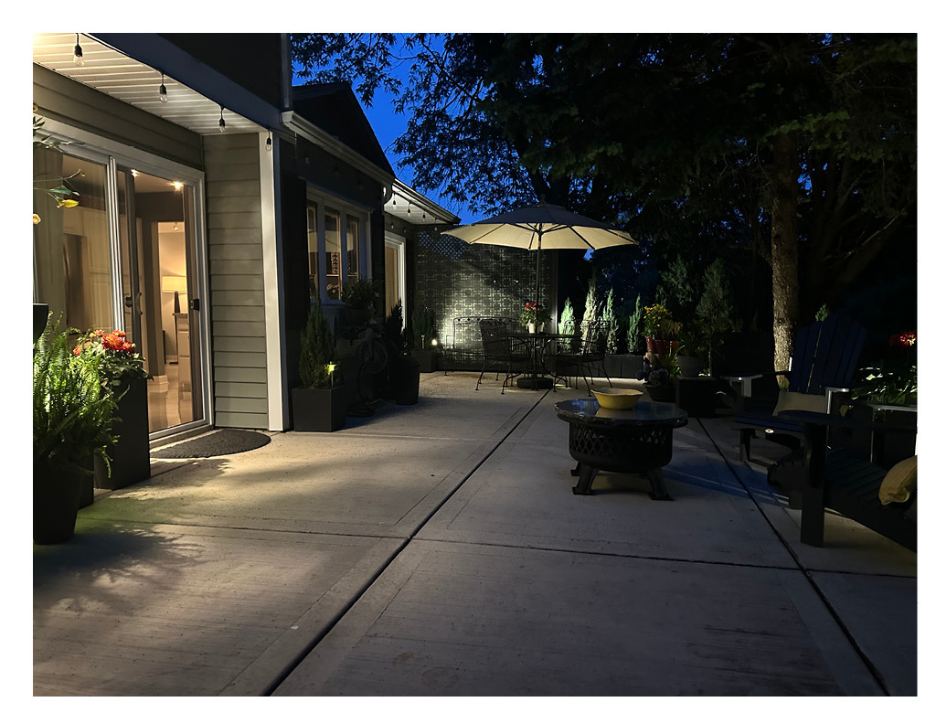 129 Regency Drive Lombard, IL 60148 - Photo 48 of 58 a view of a patio with table and chairs under an umbrella with a yard