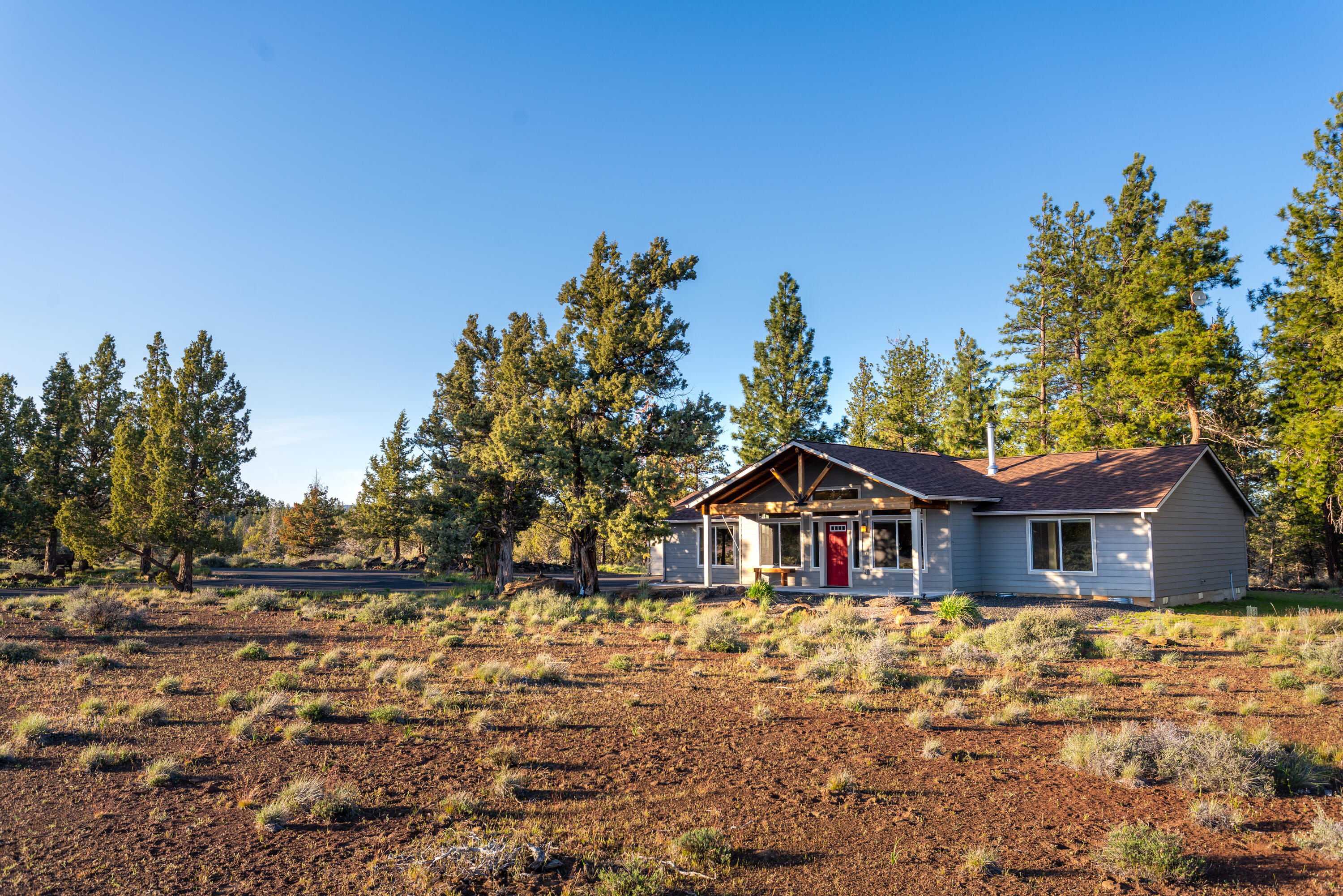 70099 Indian Ford Road Sisters, OR 97759 - Photo 1 of 27 a house view with a garden space