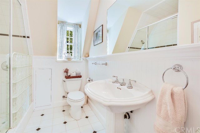 167 Cedar Circle Lake Arrowhead, CA 92352 - Photo 13 of 38 a bathroom with a sink a toilet and a mirror