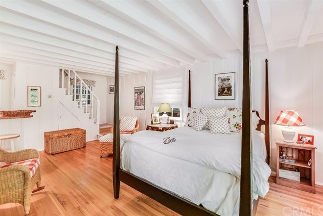 167 Cedar Circle Lake Arrowhead, CA 92352 - Photo 15 of 38 a bedroom with a bed and wooden floor