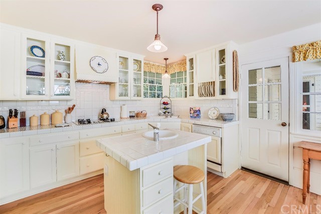 167 Cedar Circle Lake Arrowhead, CA 92352 - Photo 6 of 38 a kitchen with a sink cabinets and wooden floor