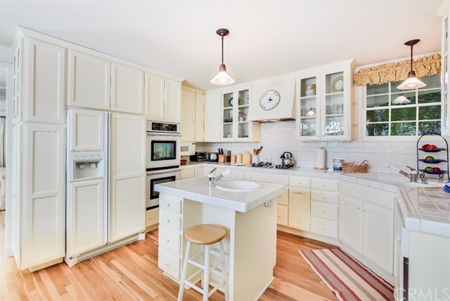 167 Cedar Circle Lake Arrowhead, CA 92352 - Photo 7 of 38 a kitchen with stainless steel appliances granite countertop a stove a sink and a refrigerator