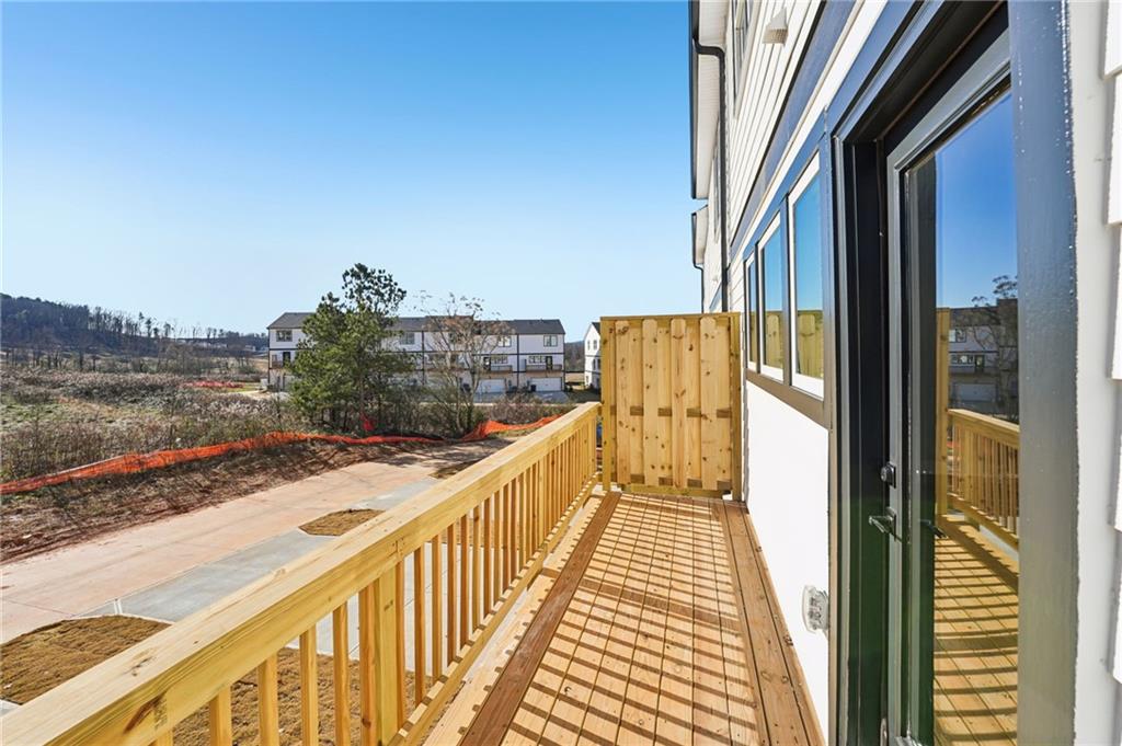 6450 Pinin Place Cumming, GA 30041 - Photo 49 of 53 a view of a balcony with wooden floor and lake view