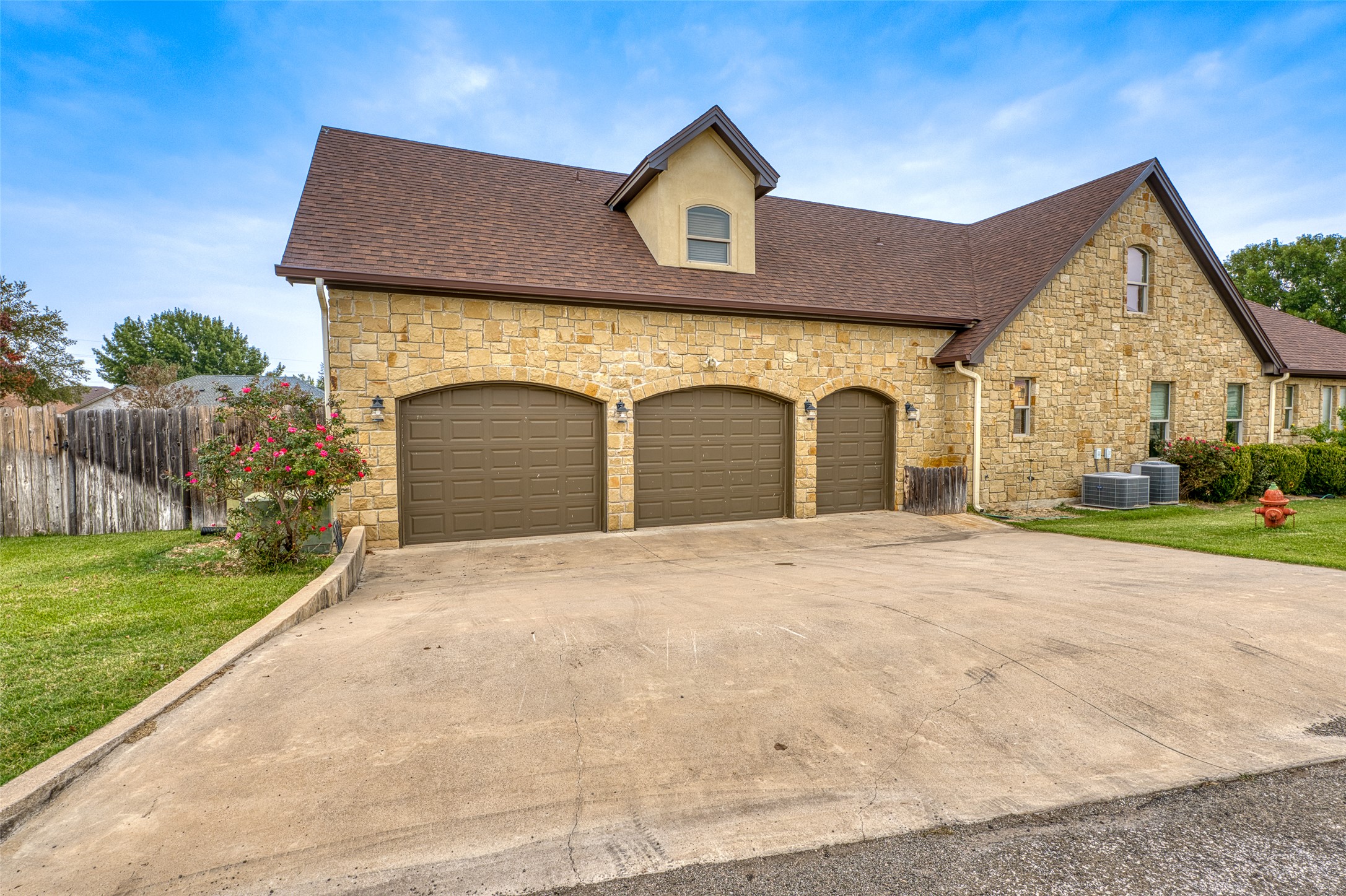 114 Preston Trail Meadowlakes, TX 78654 - Photo 22 of 23 a front view of a house with a garden and plants