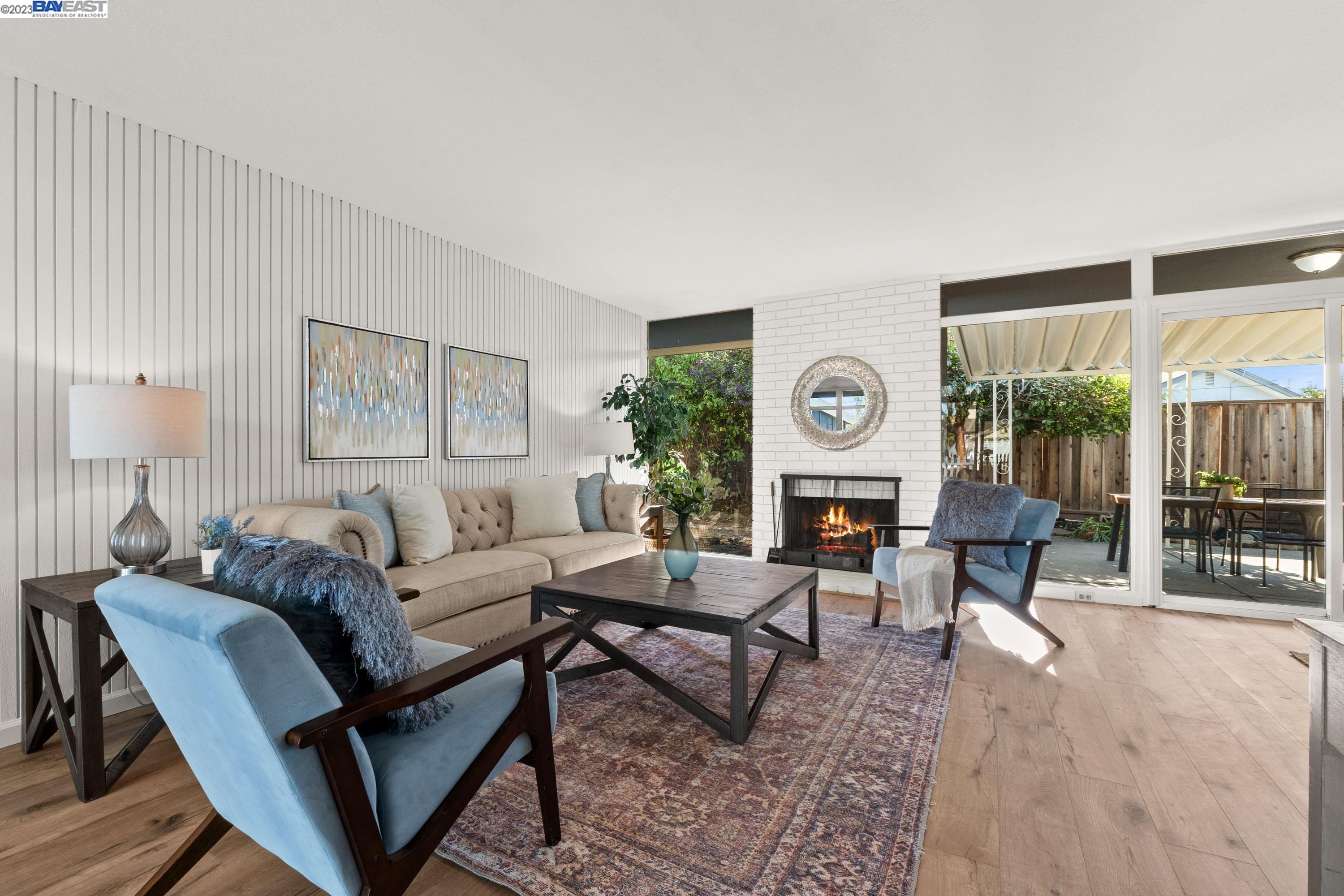 4908 Omar Street Fremont, CA 94538 - Photo 1 of 1 a living room with furniture and a clock