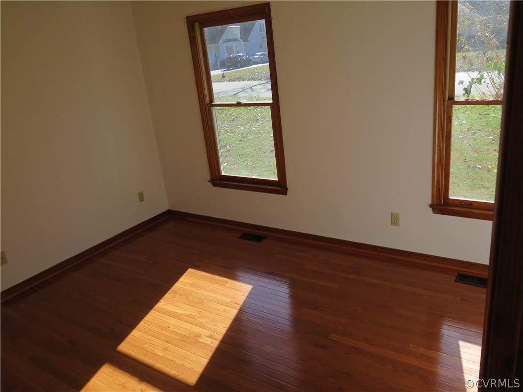 7432 Trailing Rock Road Prince George, VA 23875 - Photo 12 of 24 an empty room with wooden floor and windows