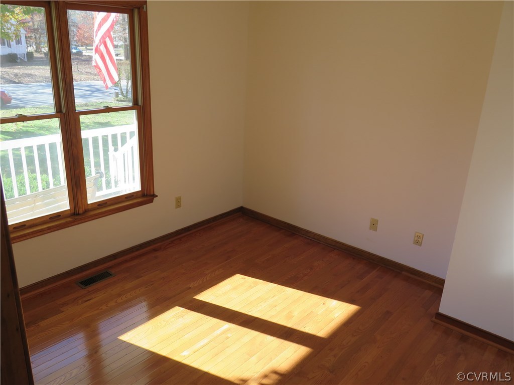 7432 Trailing Rock Road Prince George, VA 23875 - Photo 14 of 24 an empty room with wooden floor and windows