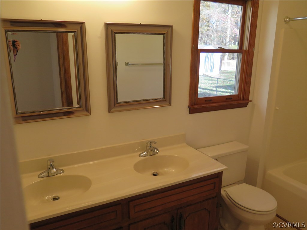 7432 Trailing Rock Road Prince George, VA 23875 - Photo 15 of 24 a bathroom with a sink mirror and toilet