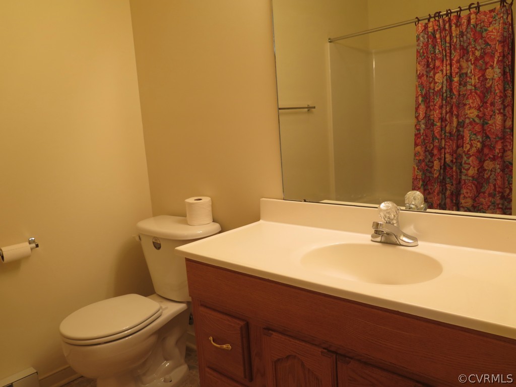 7432 Trailing Rock Road Prince George, VA 23875 - Photo 18 of 24 a bathroom with a sink a toilet and mirror