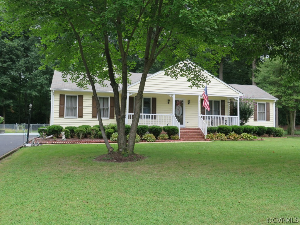 7432 Trailing Rock Road Prince George, VA 23875 - Photo 2 of 24 a front view of a house with a yard and trees