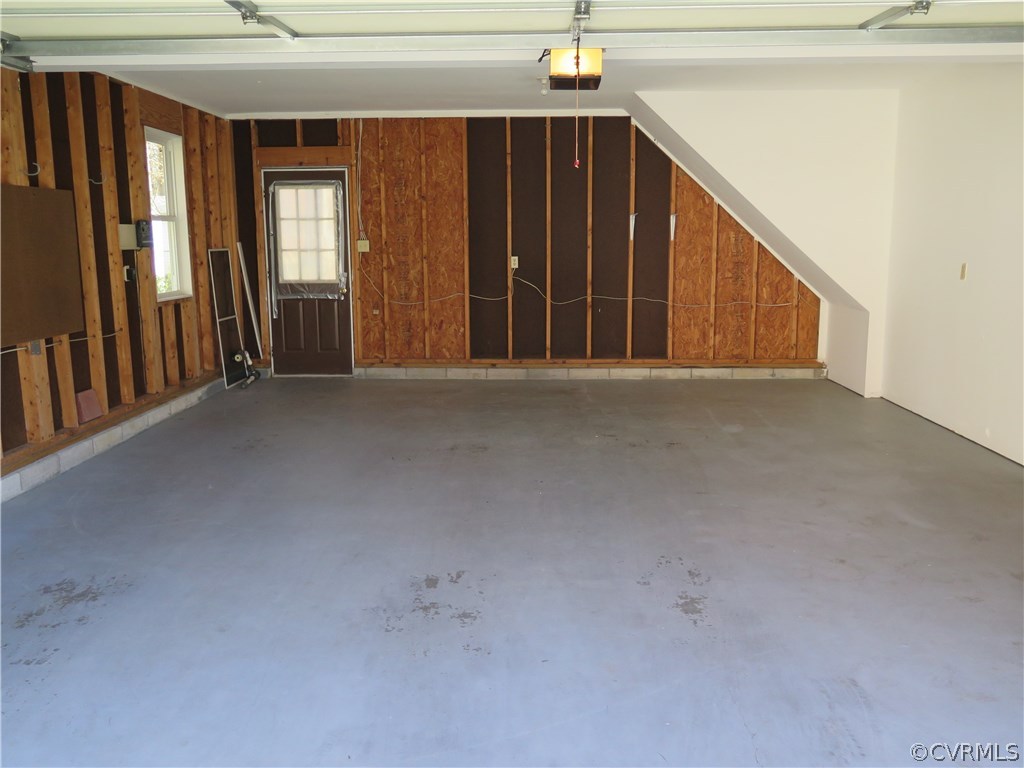 7432 Trailing Rock Road Prince George, VA 23875 - Photo 21 of 24 a view of an empty room with wooden floor and a window