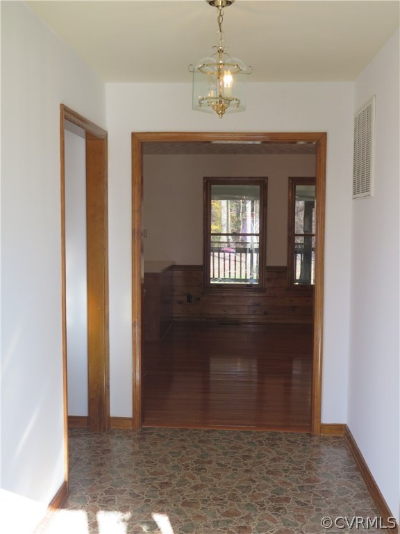 7432 Trailing Rock Road Prince George, VA 23875 - Photo 3 of 24 a view of a hallway with wooden floor and chandelier