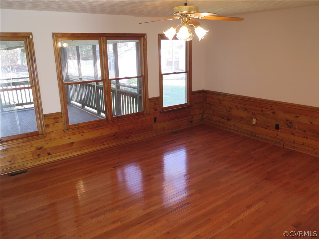 7432 Trailing Rock Road Prince George, VA 23875 - Photo 4 of 24 a view of an empty room with wooden floor and a window