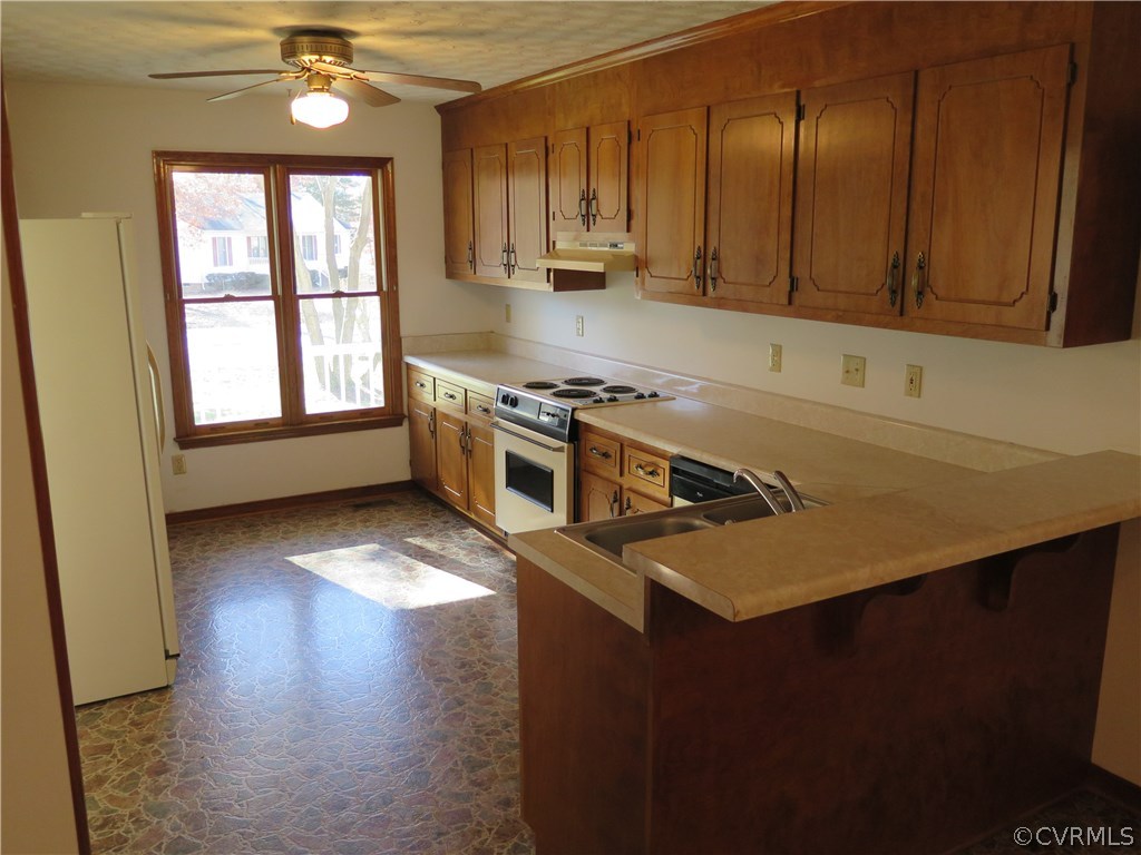 7432 Trailing Rock Road Prince George, VA 23875 - Photo 8 of 24 a kitchen with stainless steel appliances a sink dishwasher stove and wooden cabinets with wooden floor
