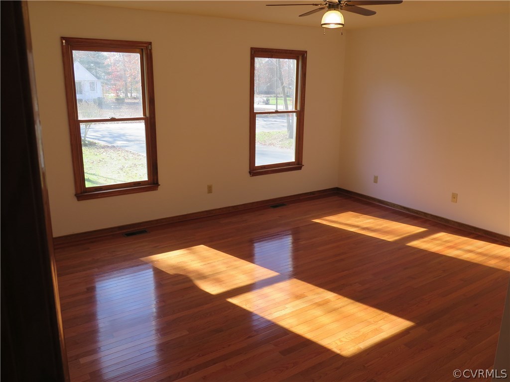 7432 Trailing Rock Road Prince George, VA 23875 - Photo 9 of 24 a view of an empty room with window and wooden floor