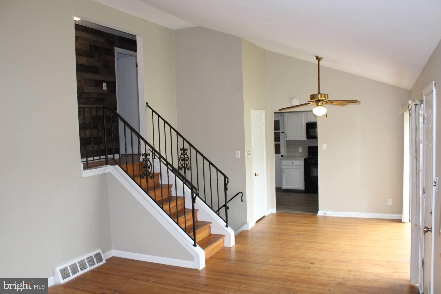 608 Whitman Street Glassboro, NJ 08028 - Photo 3 of 8 a view of a hallway with wooden floor and staircase