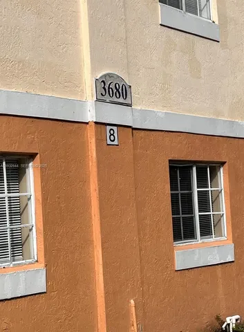 a close up of a street sign and a window