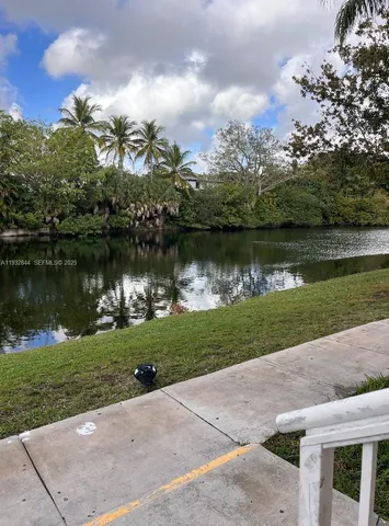 an aerial view of a house with garden and lake view