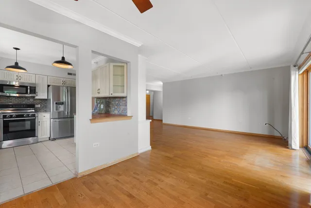 a kitchen with kitchen island granite countertop a sink appliances cabinets and a counter top space