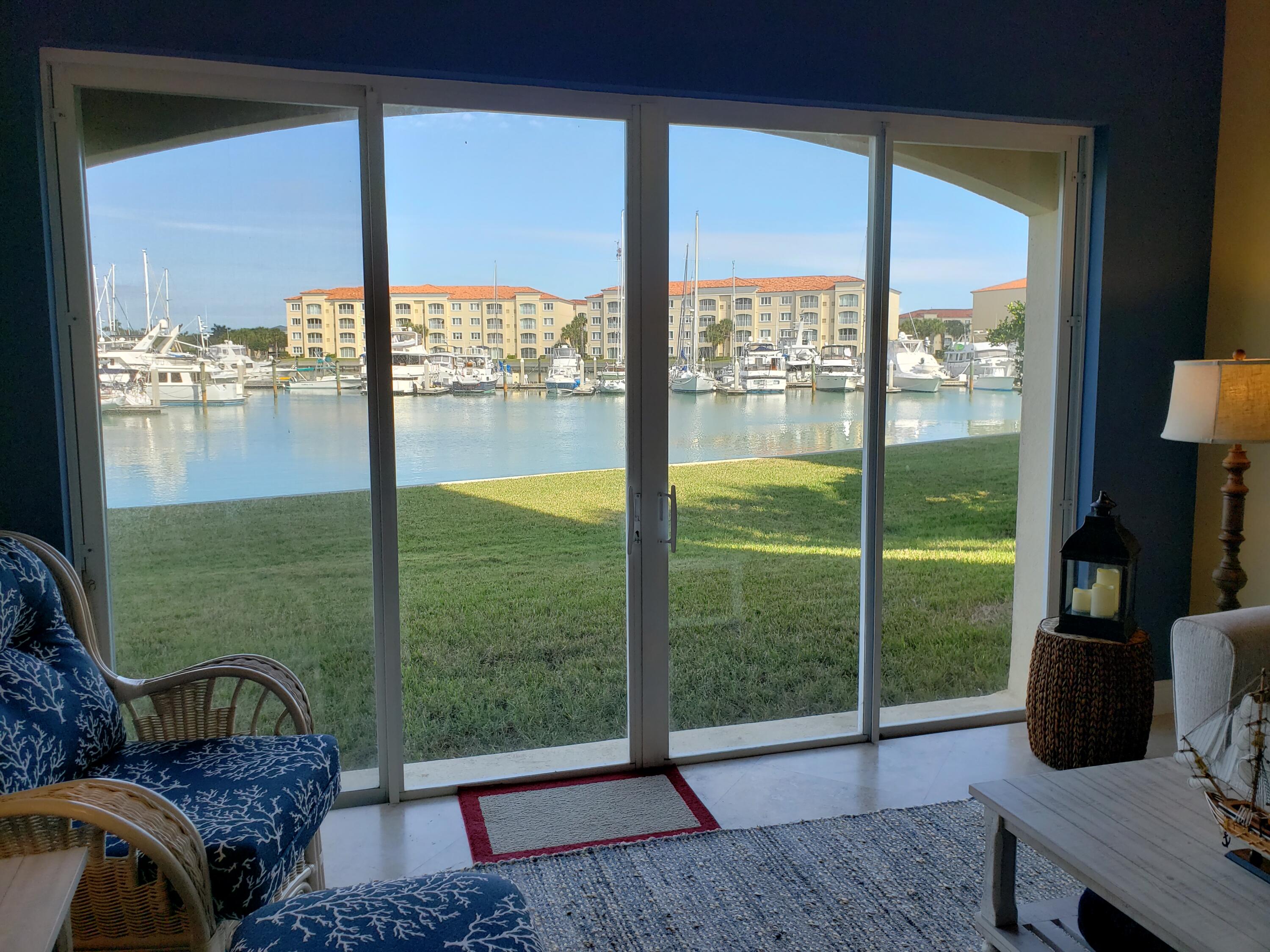 14 Harbour Isle Drive West, Unit 106 Fort Pierce, FL 34949 - Photo 11 of 23 a living room with hardwood floor and balcony