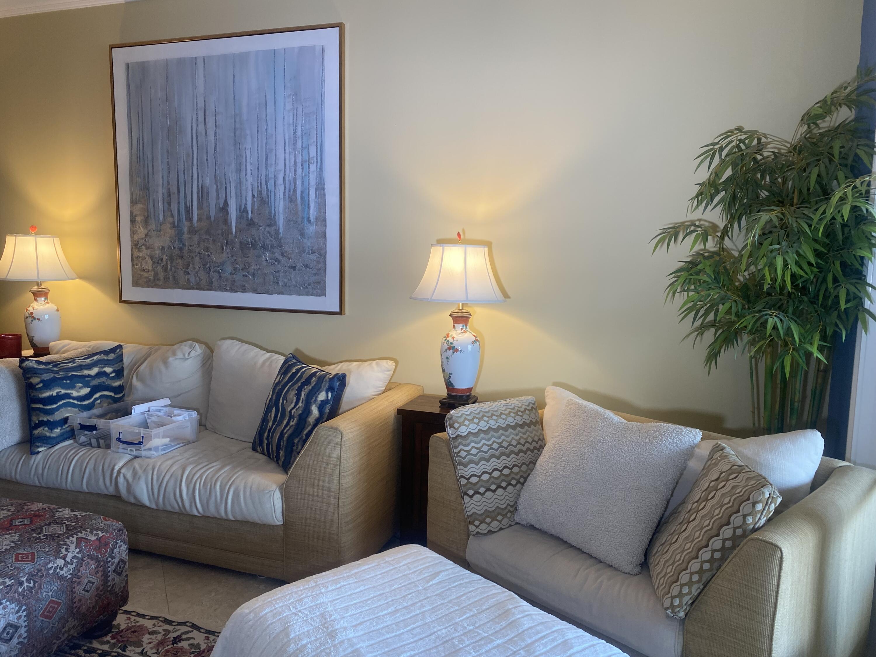 14 Harbour Isle Drive West, Unit 106 Fort Pierce, FL 34949 - Photo 9 of 23 a living room with furniture and a lamp