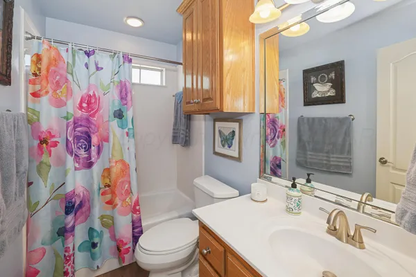 a bathroom with a sink toilet and a mirror