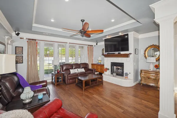 a living room with furniture a fireplace and a flat screen tv
