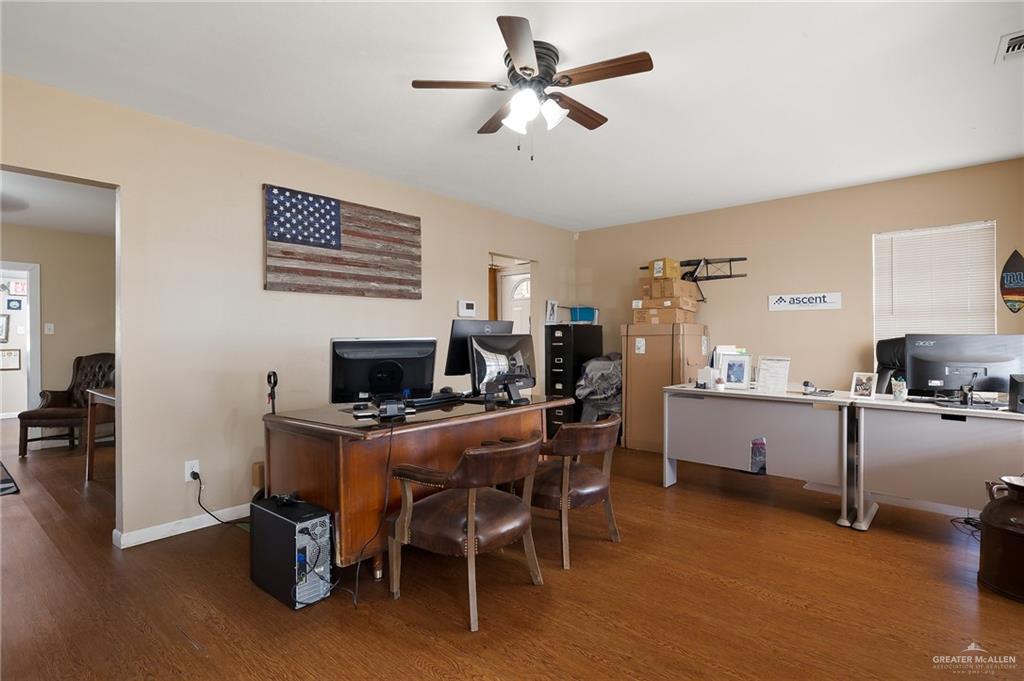 3721 North Veterans Boulevard Pharr, TX 78577 - Photo 4 of 18 Home office featuring baseboards, visible vents, ceiling fan, and wood finished floors
