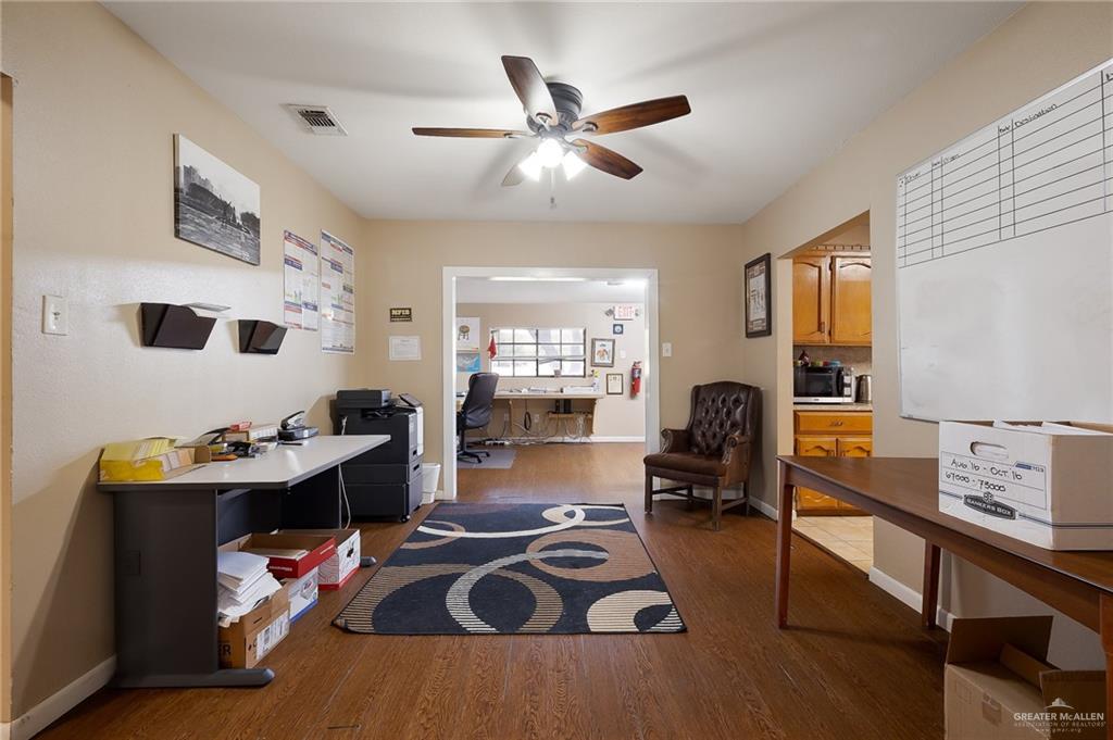 3721 North Veterans Boulevard Pharr, TX 78577 - Photo 7 of 18 Home office featuring baseboards, visible vents, a ceiling fan, and wood finished floors