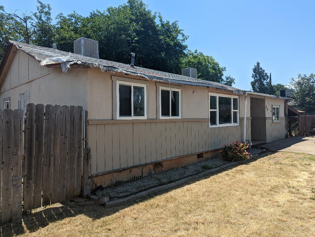 1118 4th Street Redding, CA 96002 - Photo 2 of 16 a side view of a house with a yard