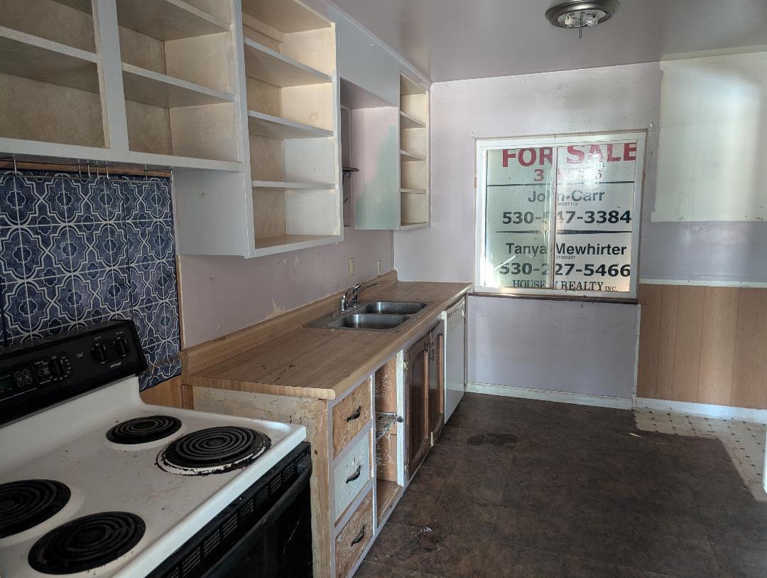 1118 4th Street Redding, CA 96002 - Photo 5 of 16 a kitchen with a stove and a window