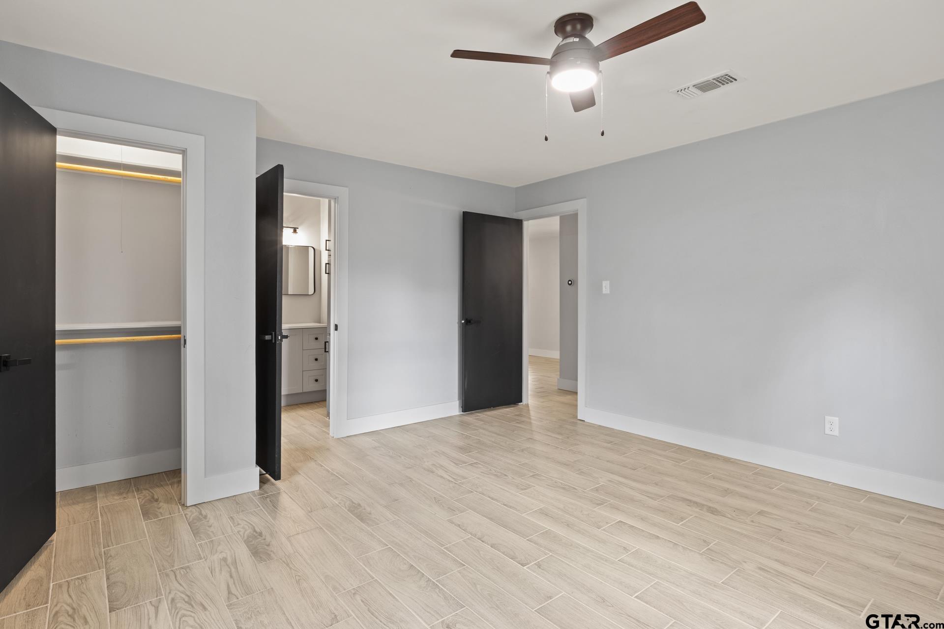 802 Quitman Street Pittsburg, TX 75686 - Photo 15 of 24 a view of empty room with wooden floor and ceiling fan