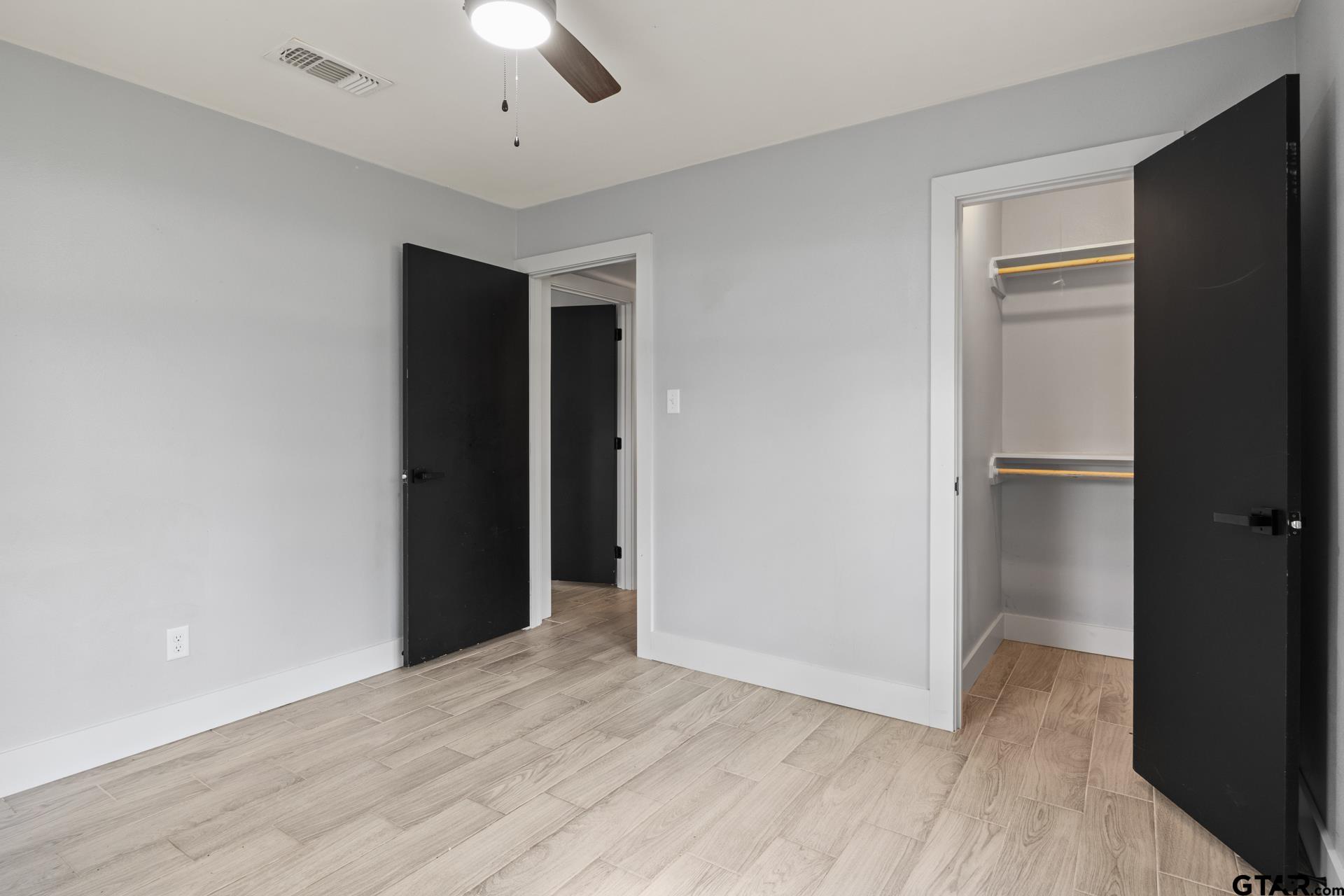 802 Quitman Street Pittsburg, TX 75686 - Photo 20 of 24 an empty room with closet and a hallway